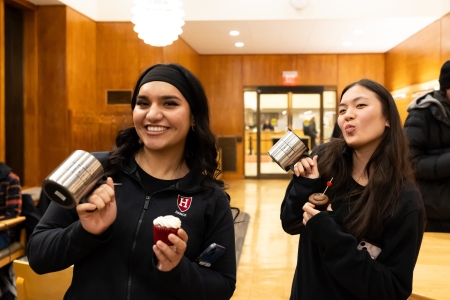 Two students pose with cupcakes